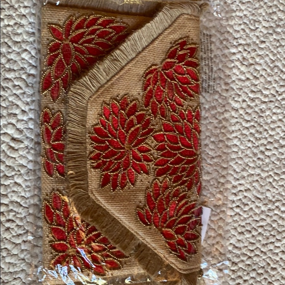 Tan clutch with red embellished flowers